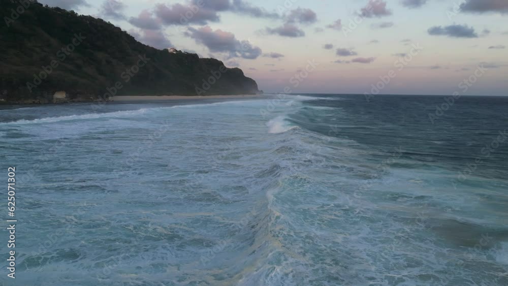 Aerial view of sandy beach with a cliff in the background Aerial view of sandy beach with a cliff in the background