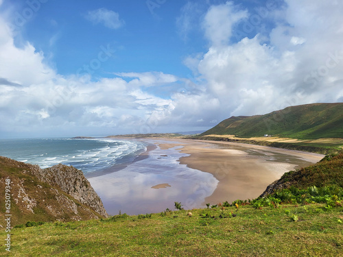 Rhossili Bay lies at the western end of the beautiful Gower peninsula. 3 miles of golden sands, iconic landscapes including Rhossili Downs and Llangennith Beach. photo