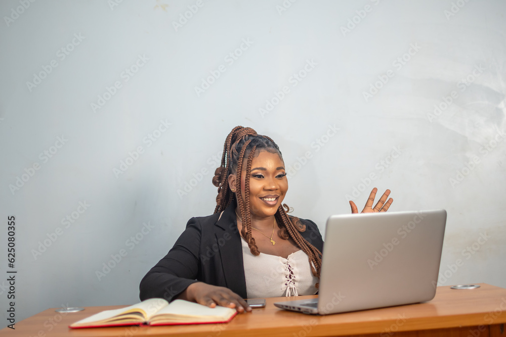 Professional African Woman Using Laptop at Office Desk Professional African Woman Using Laptop at Office Desk