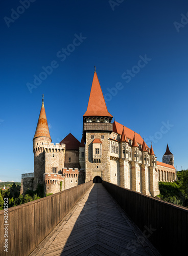 Corvin (Hunyad) Castle in Hunedoara against blue sky during a sunny day in Transylvania. Wide angle photo this amazing medieval castle landmark in Romania.