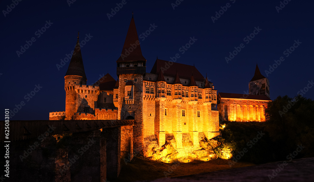 Corvin (Hunyad) Castle in Hunedoara during the evening. Wide angle night phoot with this amazing medieval castle landmark in Romania.