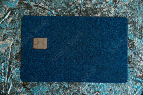 Modern bank credit card with chip on dark background