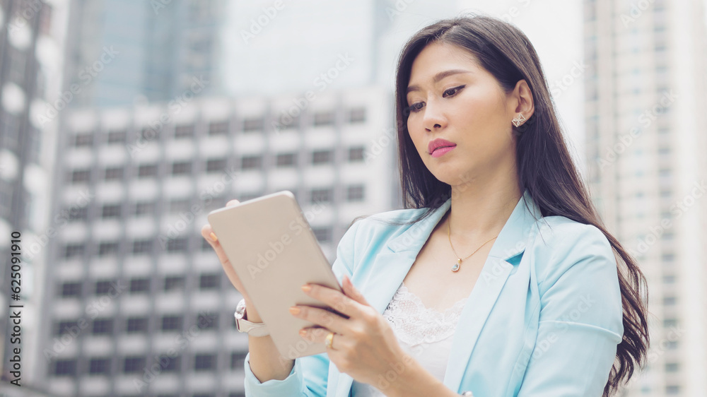 Beautiful cute girl business woman clothes holding a smart phone, urban city background Beautiful cute girl business woman clothes holding a smart phone, urban city background