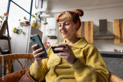 Young adult woman at home shopping on smartphone mobile