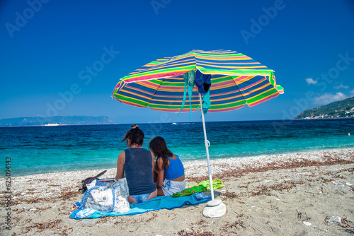 A family under the umbrella in the summer sun © jovannig
