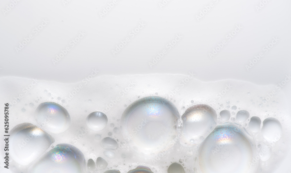 Foam border design on white background. Liquid soap bubbles, Foam bubbles background. Soap foam popping bubble, white backdrop. Soap sud macro structure. Soap foam close-up. Clean, cleaning, washing 