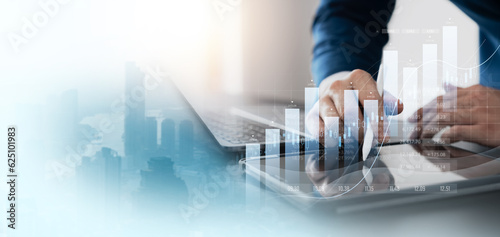 finance with a professional businessman use using laptop and tablet analyzing financial data, graph growth chart in action. perfect business plan, strategy, and solution.