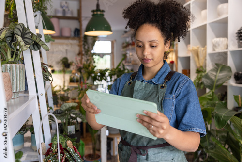 Plant shop owner using a digital tablet in store