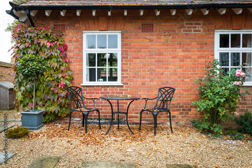 UK hard landscaped garden in autumn with garden patio furniture