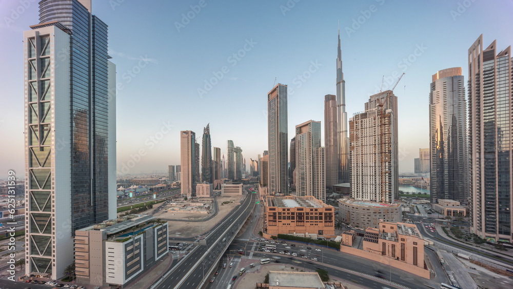 Fototapeta premium Aerial panoramic view of Dubai Downtown skyline with many towers day to night timelapse.