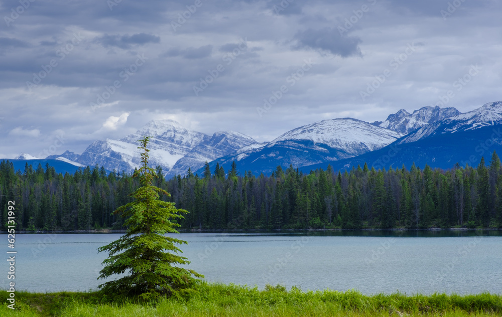 Annette Lake with snow-capped mountains in Jasper National Park, Canada.