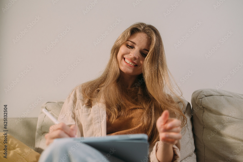 Young blonde woman working on the sofa Young blonde woman working on the sofa