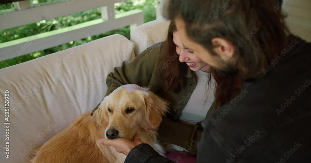 Guy brunette girl stroking a light-colored dog in a gazebo in nature. A girl in a green jacket and a light-colored dog interact in a gazebo in nature Guy brunette girl stroking a light-colored dog in a gazebo in nature. A girl in a green jacket and a light-colored dog interact in a gazebo in nature