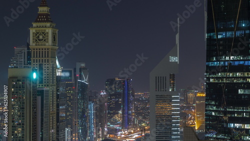 Skyline view of the high-rise buildings on Sheikh Zayed Road in Dubai aerial night timelapse, UAE. © neiezhmakov