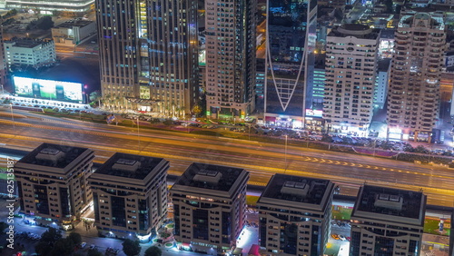 Buildings on Sheikh Zayed Road in Dubai aerial night timelapse, UAE.