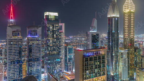 Skyline view of the high-rise buildings on Sheikh Zayed Road in Dubai aerial night timelapse, UAE.