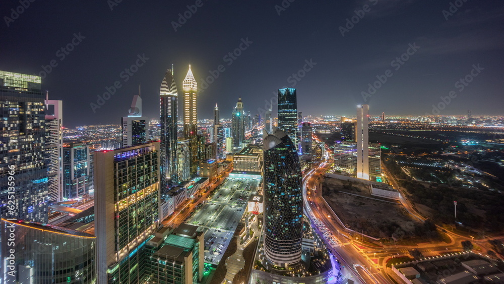Fototapeta premium Skyline panoramic view of the high-rise buildings on Sheikh Zayed Road in Dubai aerial night timelapse, UAE.