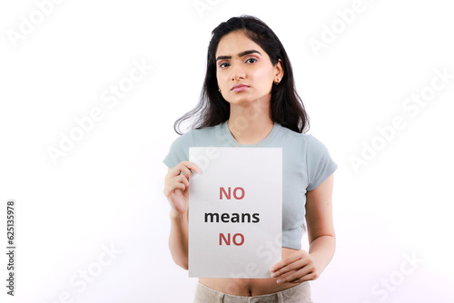 No Means No Slogan Held and Shown by Young Indian female standing - Women's Rights Demonstration - Poker Facial Expressions  photo