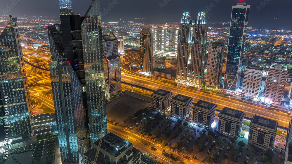 High-rise buildings on Sheikh Zayed Road in Dubai aerial night to day timelapse, UAE.