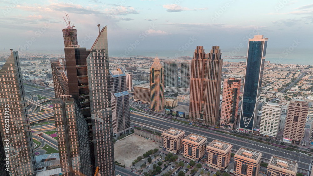 Obraz premium High-rise buildings on Sheikh Zayed Road in Dubai aerial morning timelapse, UAE.