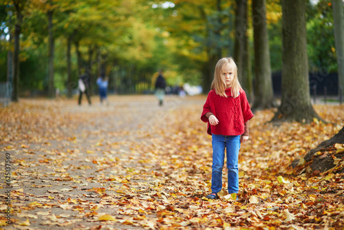 Moody preschooler girl at autumn day outdoors