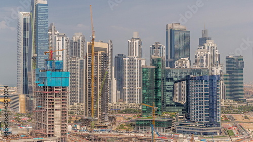 Cityscape with skyscrapers of Dubai Business Bay and water canal aerial timelapse.