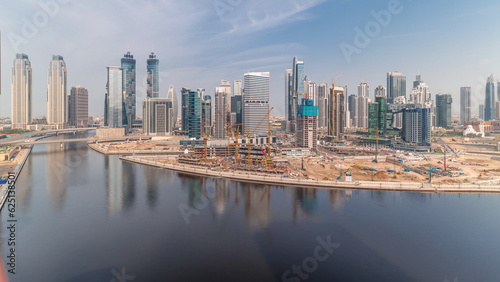 Cityscape with skyscrapers of Dubai Business Bay and water canal aerial timelapse. © neiezhmakov