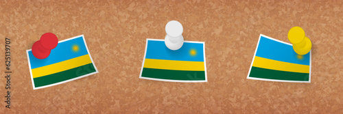 Rwanda flag pinned in cork board, three versions of Rwanda flag.
