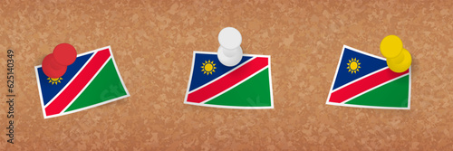 Namibia flag pinned in cork board, three versions of Namibia flag.