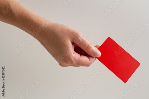 hand holding red plastic card isolated on white background