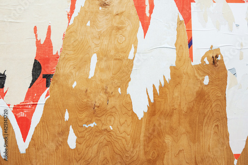 Scraps of colorful paper posters on wooden background