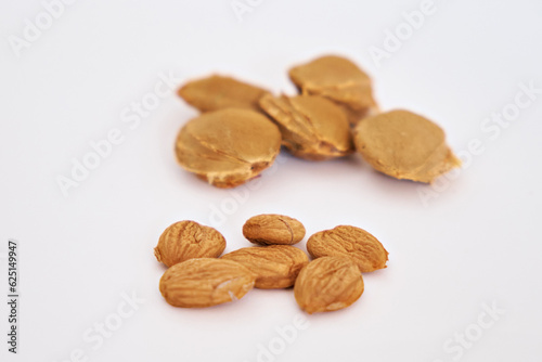Apricot kernels on a background of seeds. Selective focus. Vitamin B 17. Healthy food background. Side view