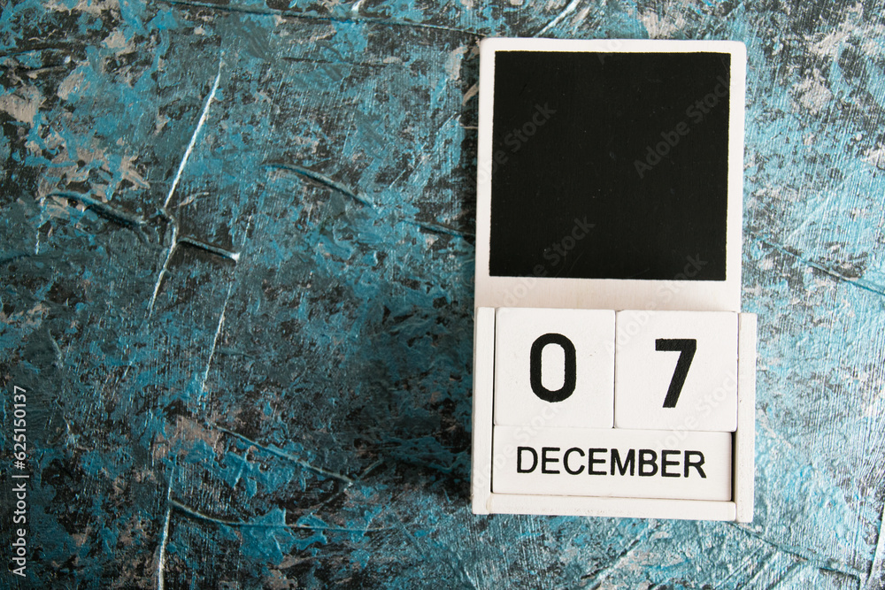 Obraz premium Wooden calendar on a dark background. International Civil Aviation Day