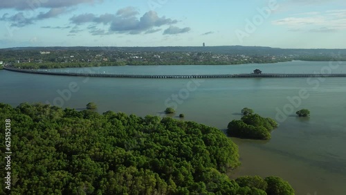 View of the toll road across the ocean and the island of Bali. In the foreground are green mangrove forests around Benoa Bay in the Indian Ocean. We fly over the island on a drone, a great view. photo