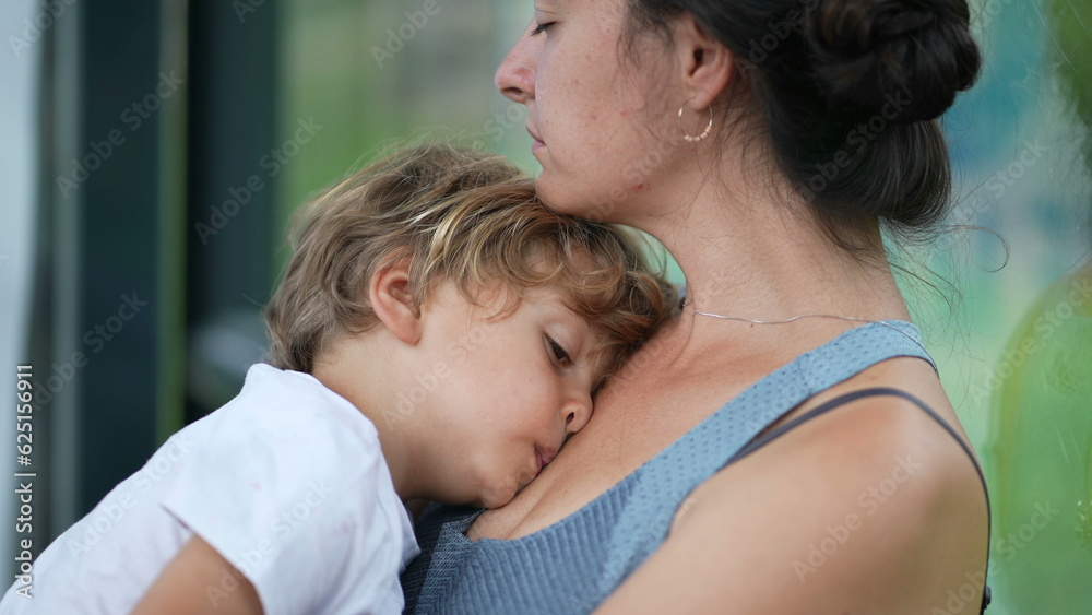 Sleepy child and mother tired parent and kid waiting together pensive woman holding small boy Sleepy child and mother tired parent and kid waiting together pensive woman holding small boy