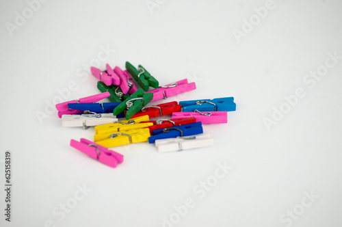 Mixed color pegs on a white background