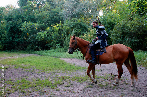 Fantasy armored warrior riding a horse