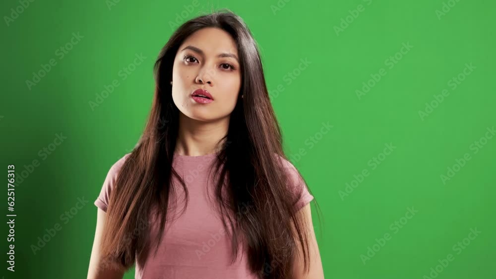 Asian Girl in a studio turning to the camera - extreme slow motion shot Asian Girl in a studio turning to the camera - extreme slow motion shot
