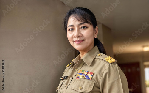 photo of middle aged asian woman in Thai teacher uniform, generative AI © Flash