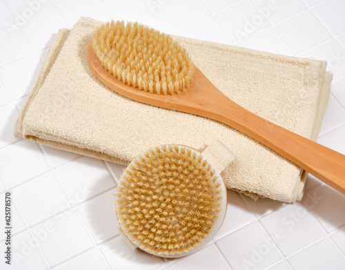 Two shower brushes and clean towels. Supplies for personal hygiene.