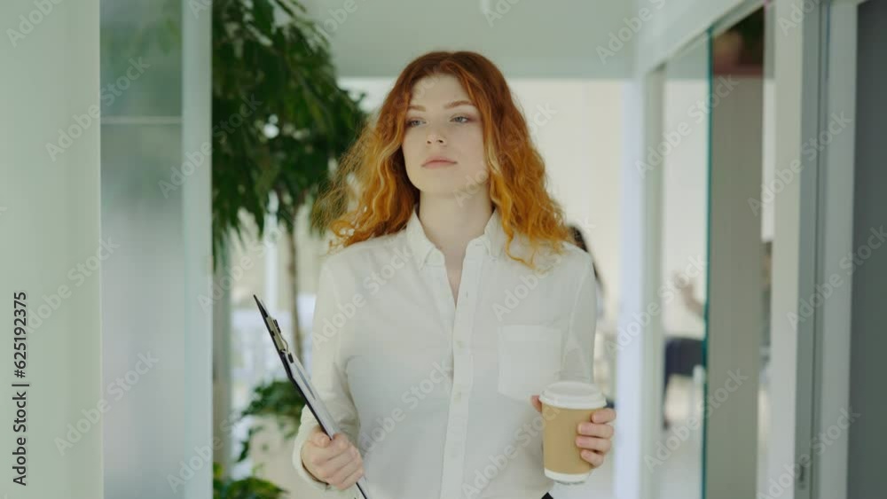 Busy Businessman with Red Hair Walking Through Corridor Holding Coffee and Papers. Busy Businessman with Red Hair Walking Through Corridor Holding Coffee and Papers.