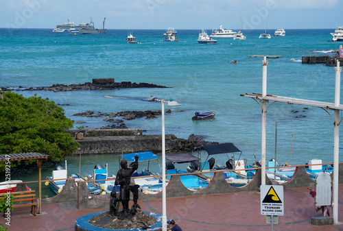 A view of Puerto Ayora, sculpture, promenade and boats, Santa Cruz island, Galapagos  photo