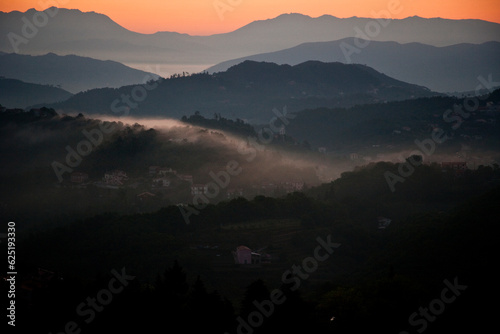 Sunset in a mountain range with mountains backlit photo