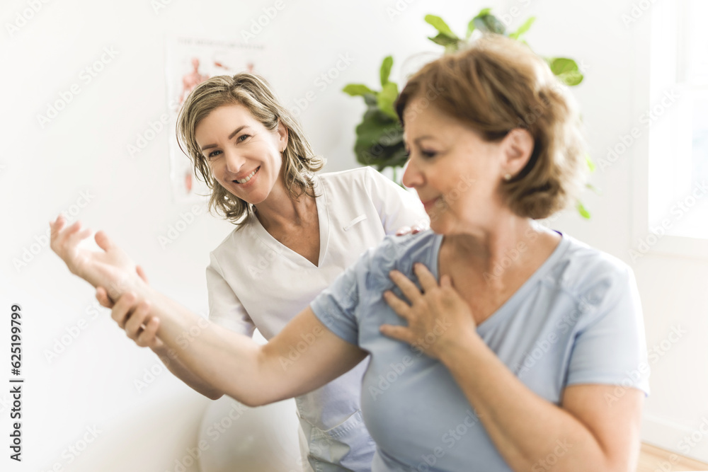 Physiotherapist working with elderly patient in clinic