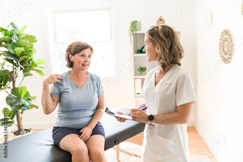 Physiotherapist working with elderly patient in clinic