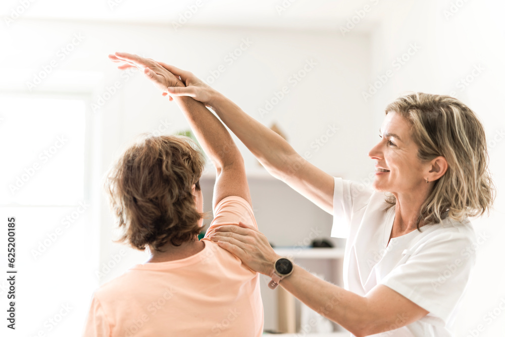Physiotherapist working with elderly patient in clinic Physiotherapist working with elderly patient in clinic