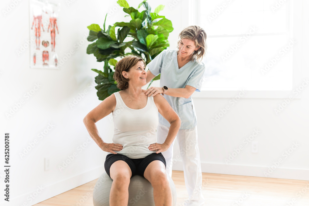 Physiotherapist working with elderly patient in clinic Physiotherapist working with elderly patient in clinic