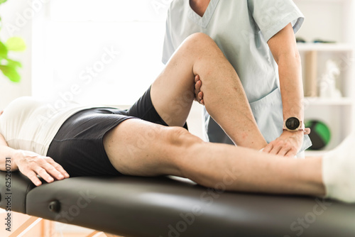 Physiotherapist working with elderly patient in clinic