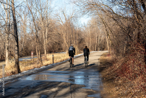 Bicycle riders on the Fox River Trail In Allouez, Wisconsin, In February © Barbara
