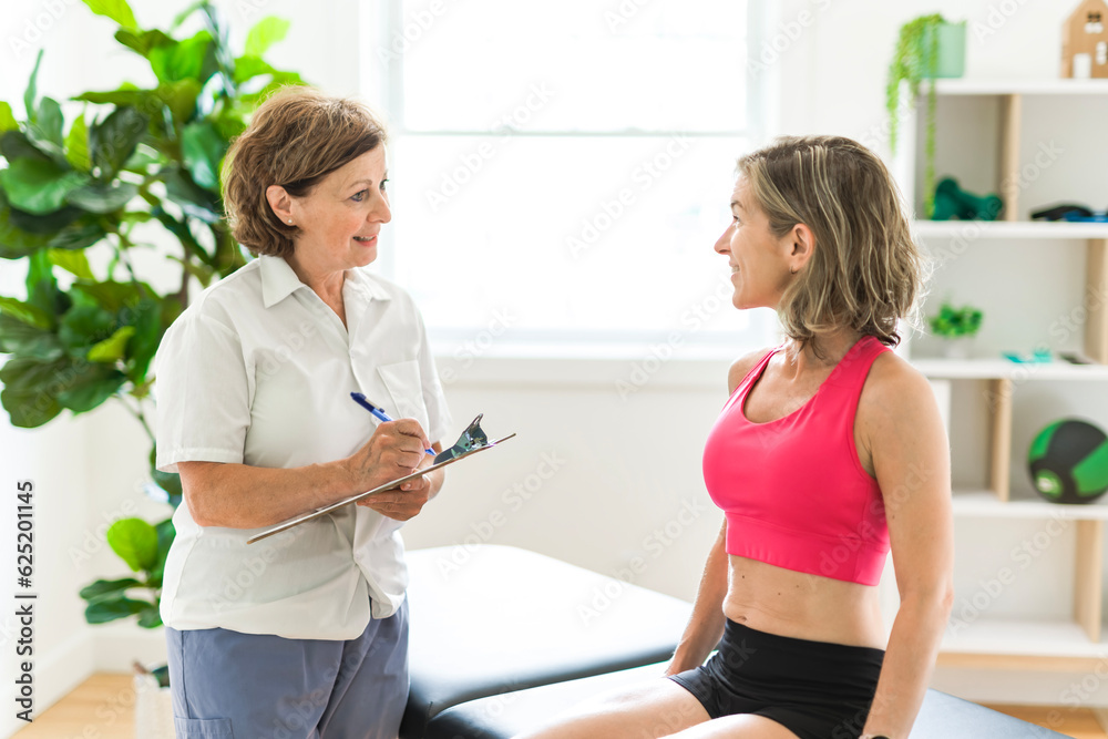 elderly Physiotherapist working with sporty patient in clinic